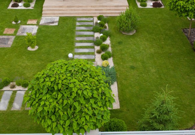 Garden with walkways and green grass. Photo taken from above drone.